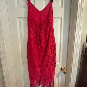 Gorgeous shocking pink midi dress with laced back and fringed hem line